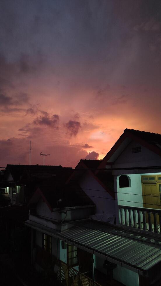 rooftops with beautiful sunset in the background photo