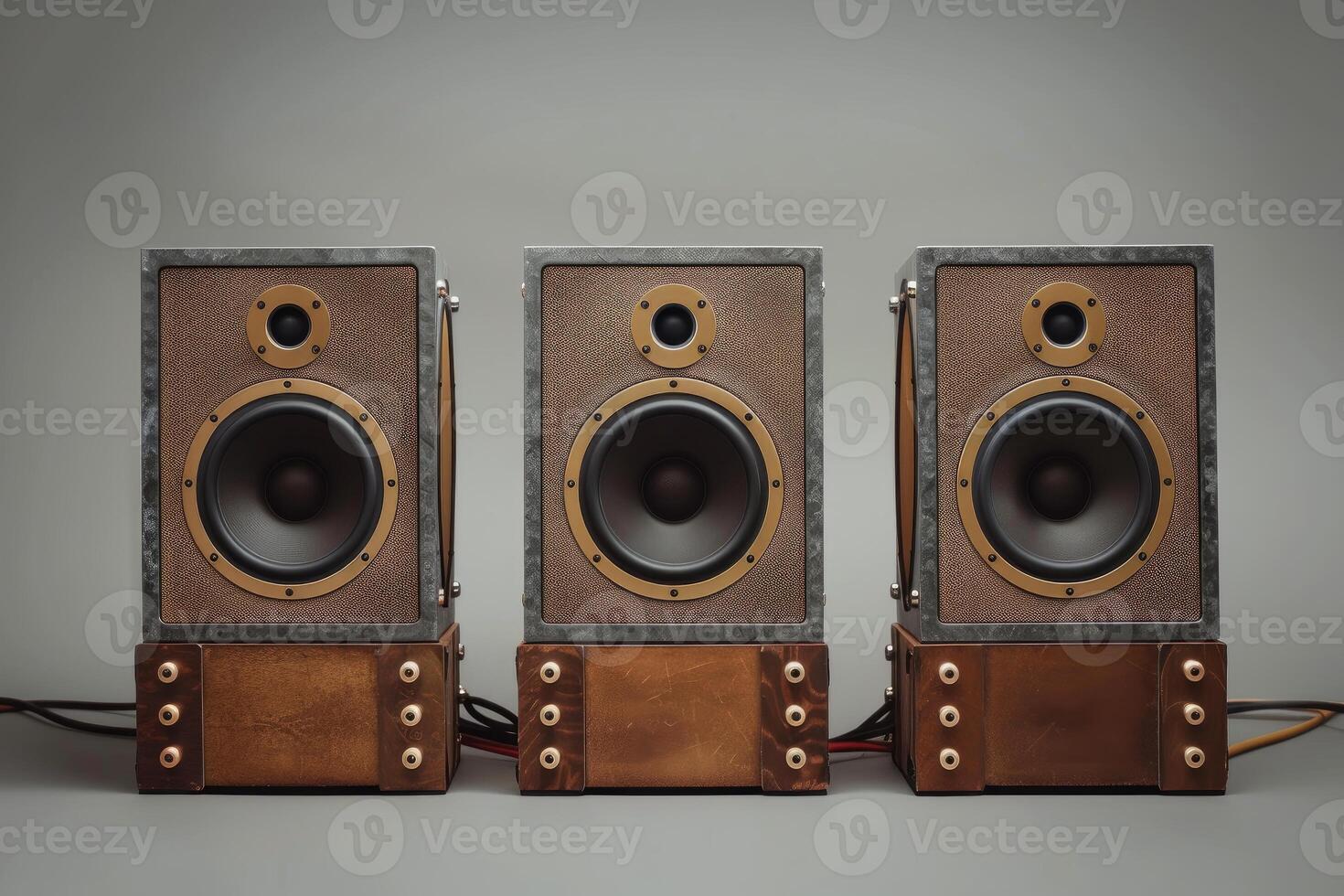 Three retro style audio speakers standing on gray background photo
