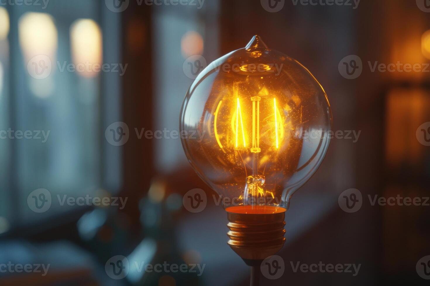 Closeup of a vintage light bulb emitting a warm glow photo