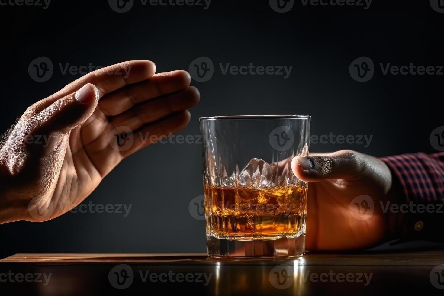 Man refusing glass of alcoholic beverage offered by bartender photo
