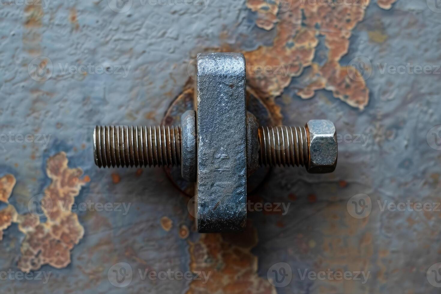 Rusty screw holding metal plate on a rusty metal surface photo