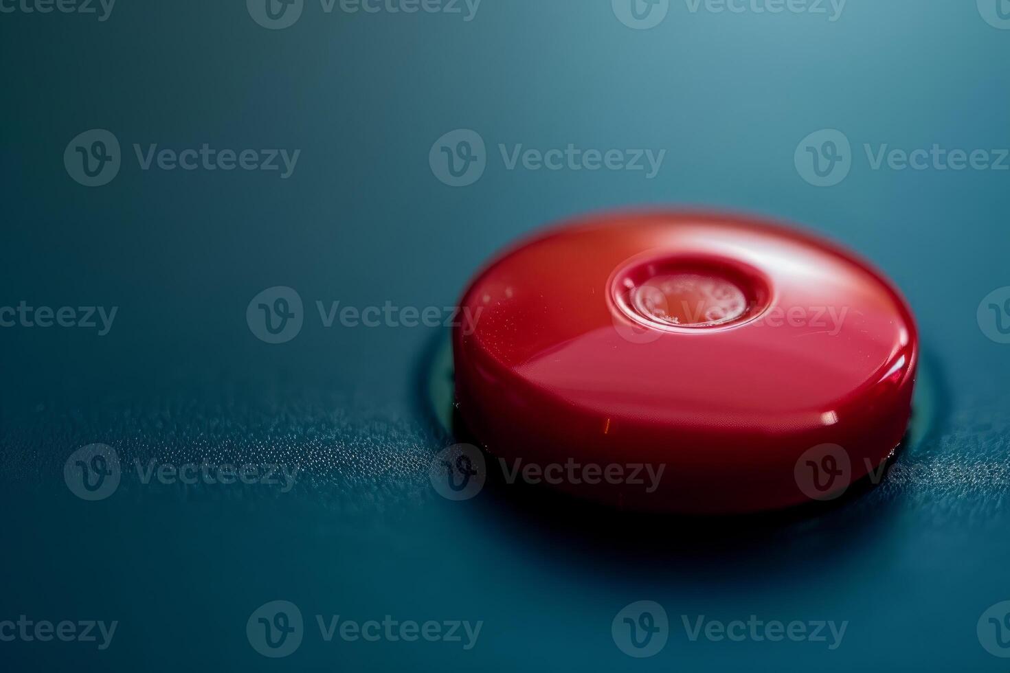 Shiny red button sitting on blue control panel photo