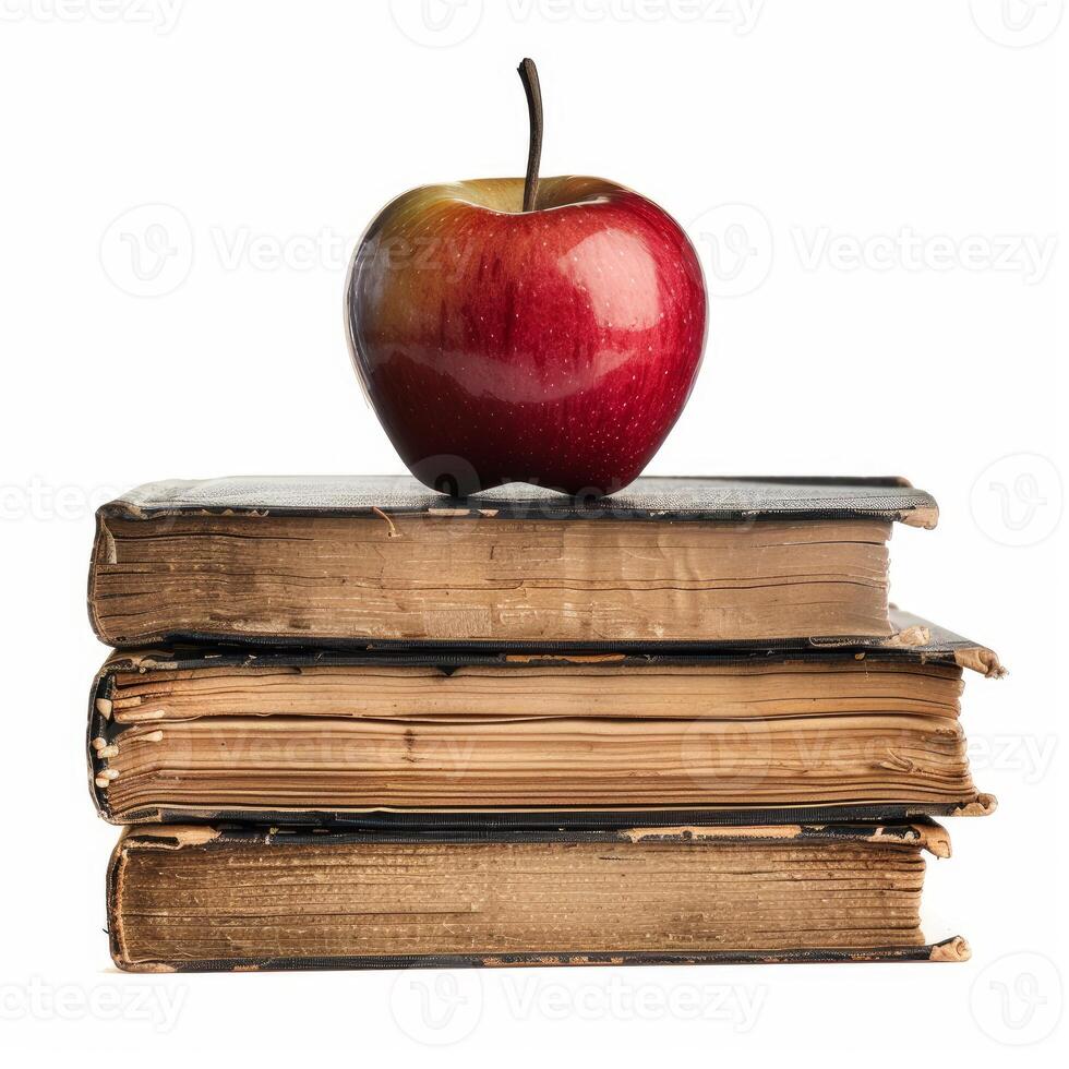 Red apple resting on stack of old books symbolizing knowledge and learning photo
