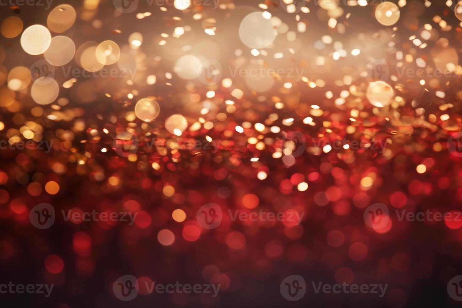 Golden confetti falling on red and orange bokeh lights background photo