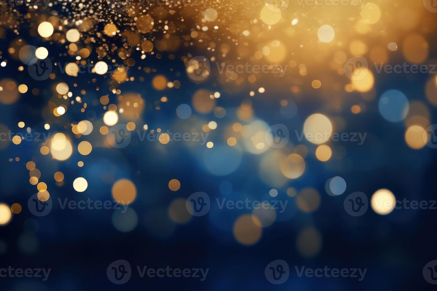 Golden particles falling and creating festive bokeh on blue background photo
