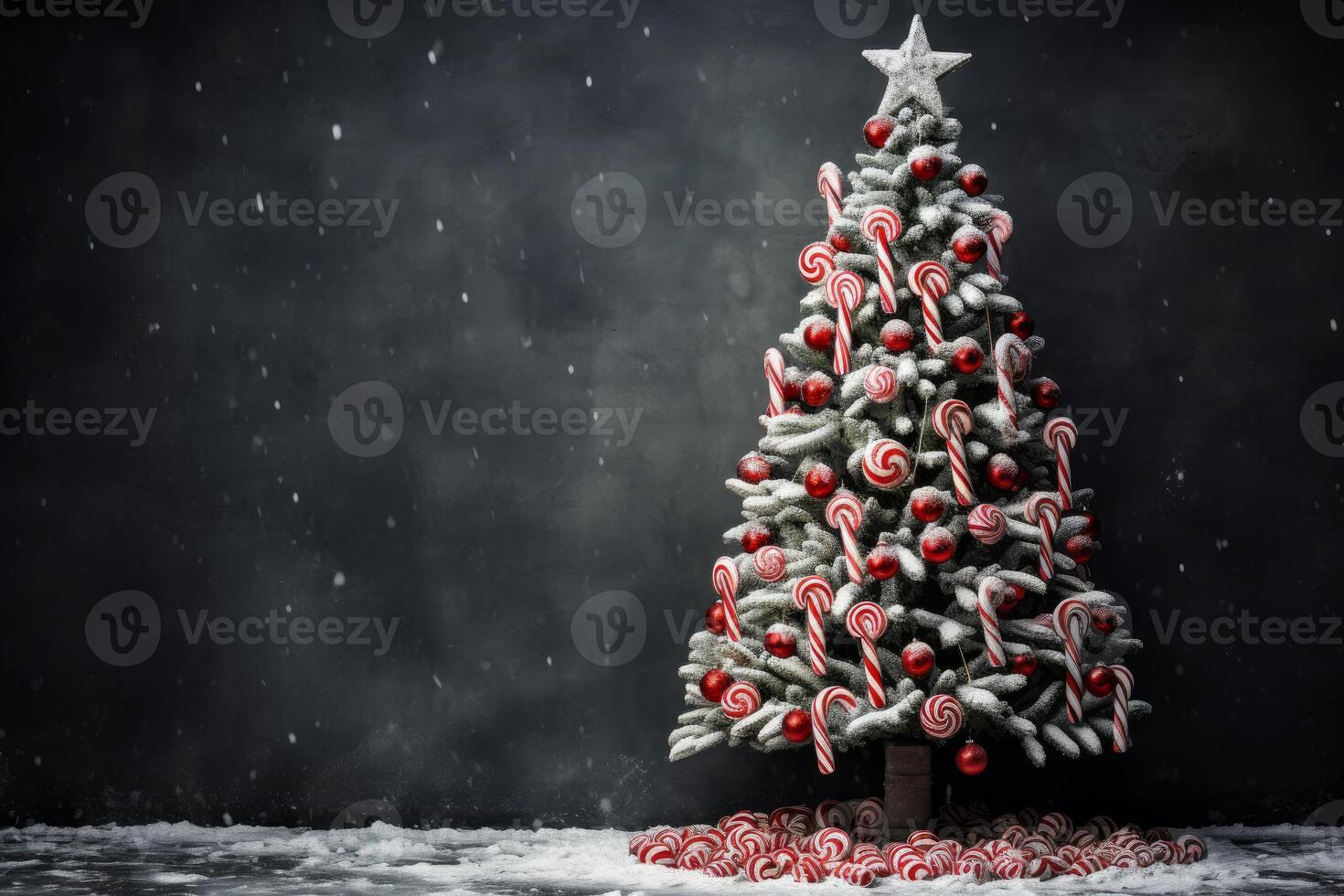 Christmas tree decorated with candy canes and red balls is standing on snowy ground photo