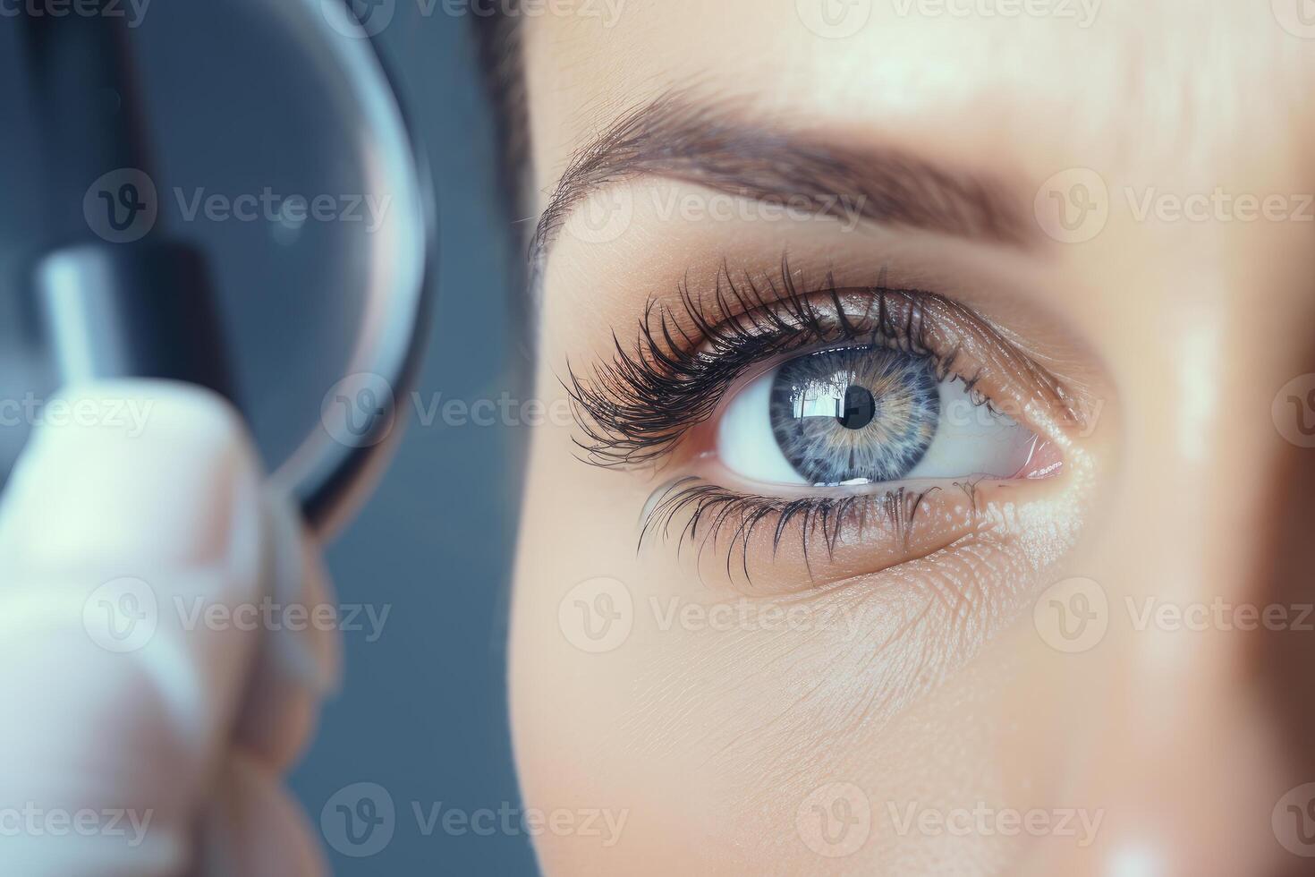 Doctor performing eye examination using magnifying glass photo