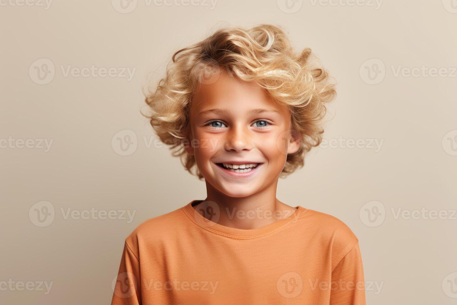 Portrait of smiling blond boy with curly hair on beige background photo