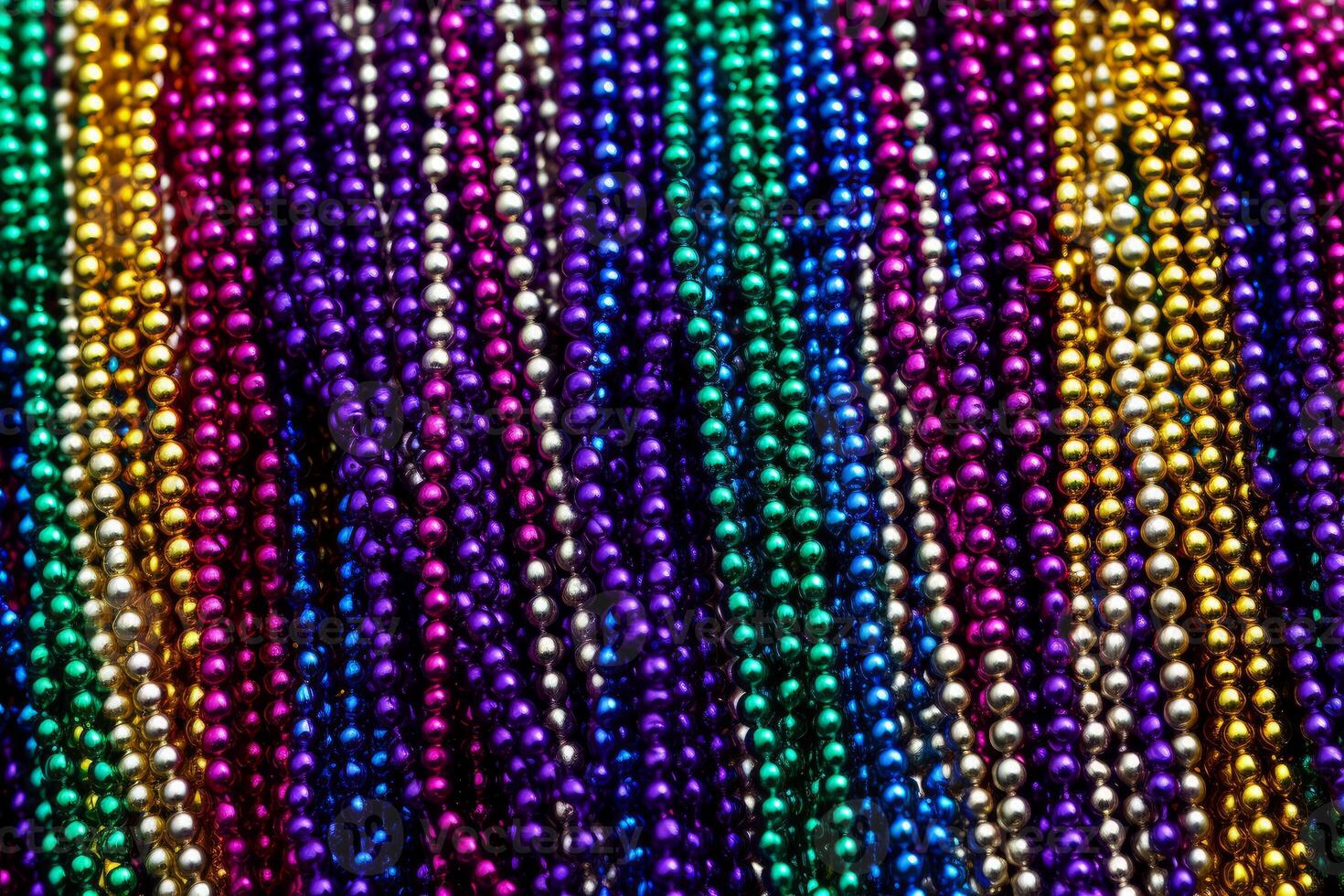 Colorful mardi gras beads forming a festive background photo