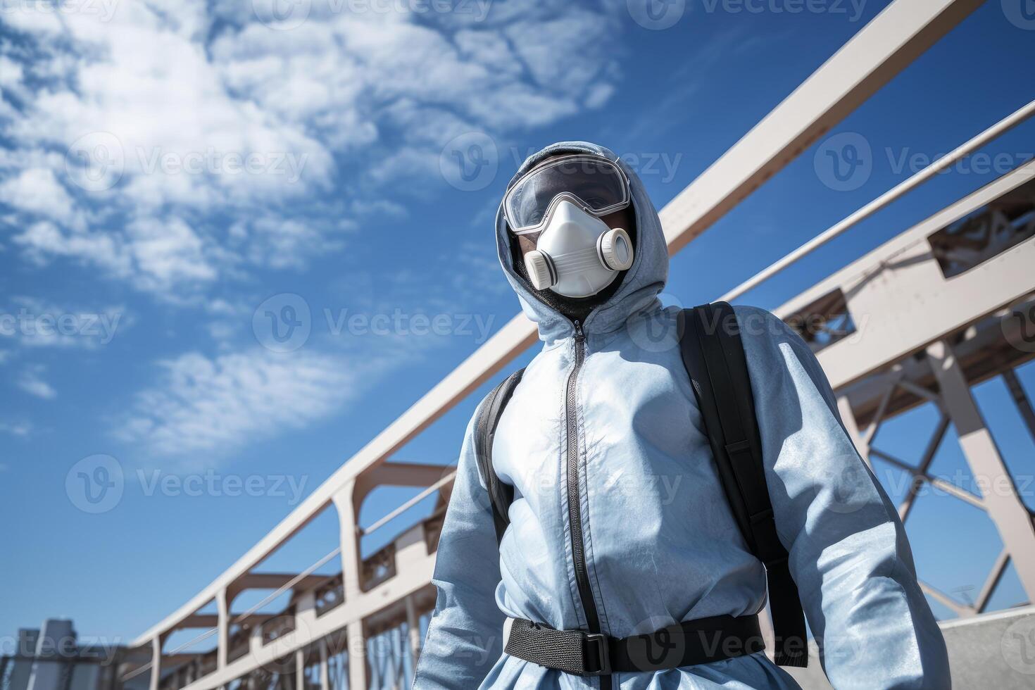 Scientist wearing hazmat suit and mask crossing bridge during pandemic photo