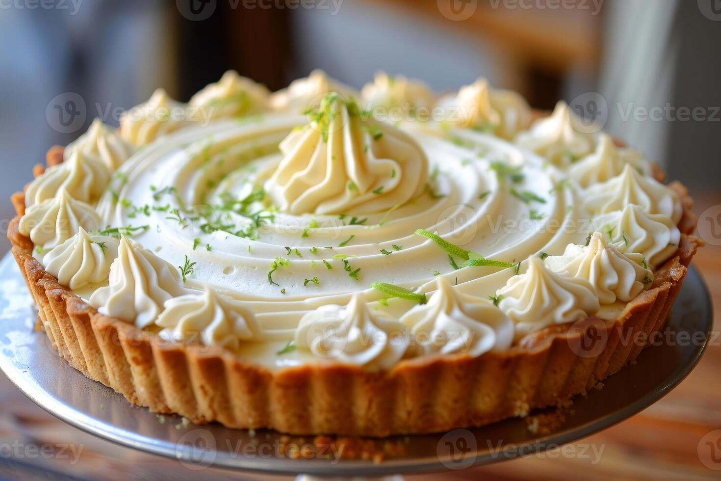 Delicious key lime pie showing swirls of meringue topping and lime zest photo