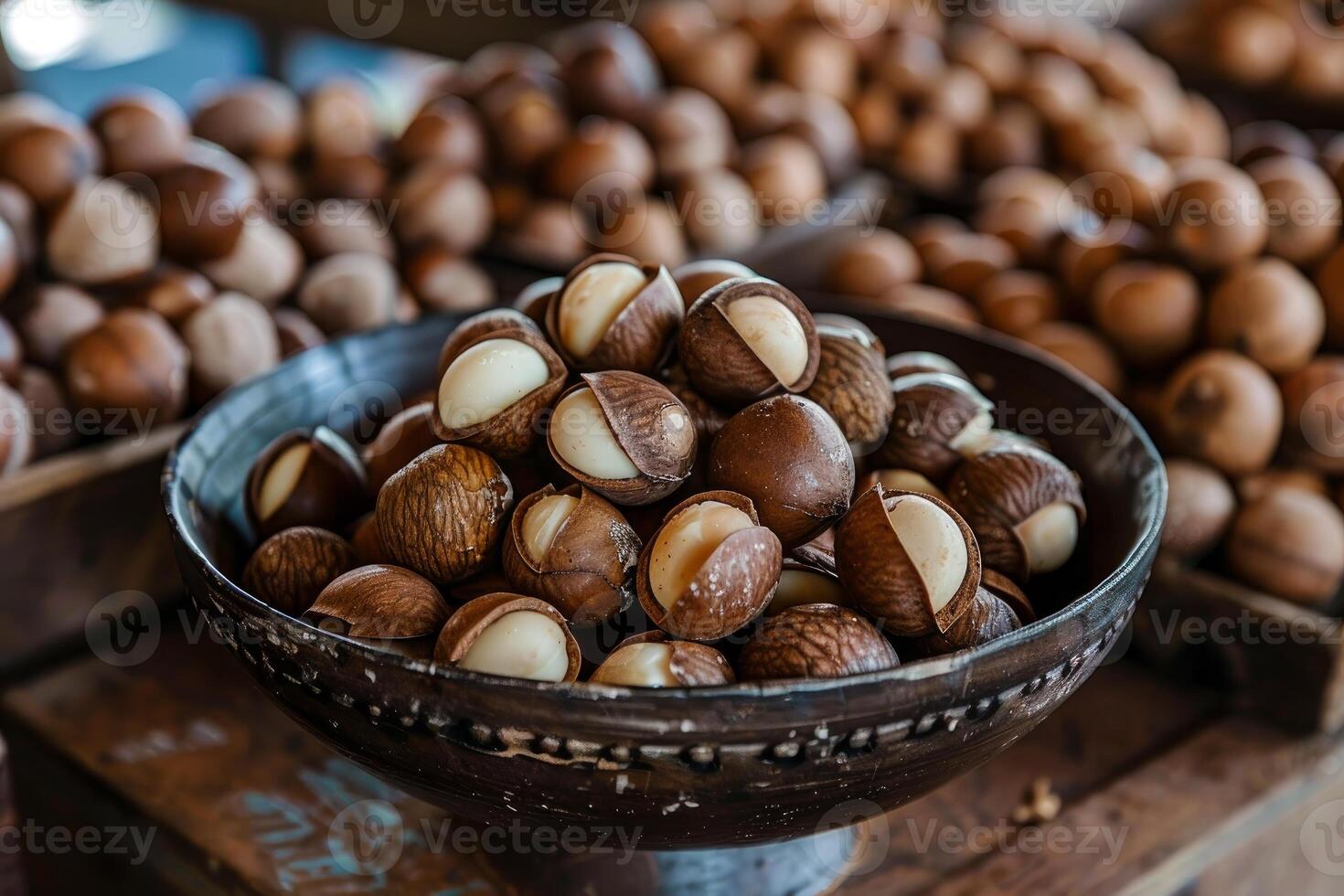 Macadamia nuts piled in a bowl at a market stall displaying fresh produce photo