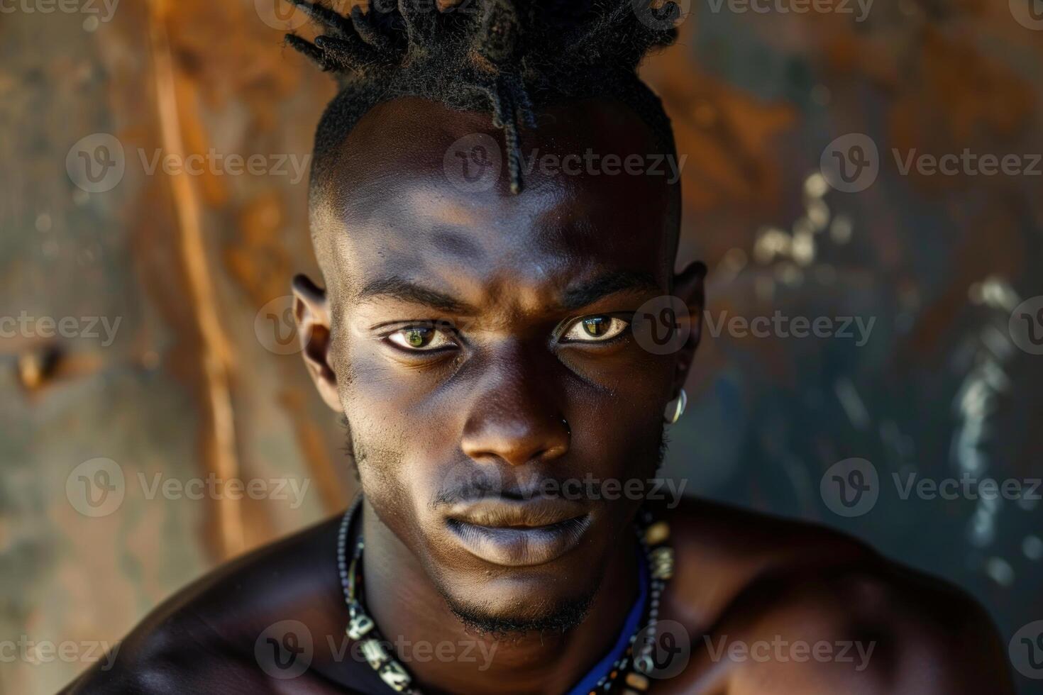 Young african model posing with expressive gaze and dreadlocks hairstyle photo