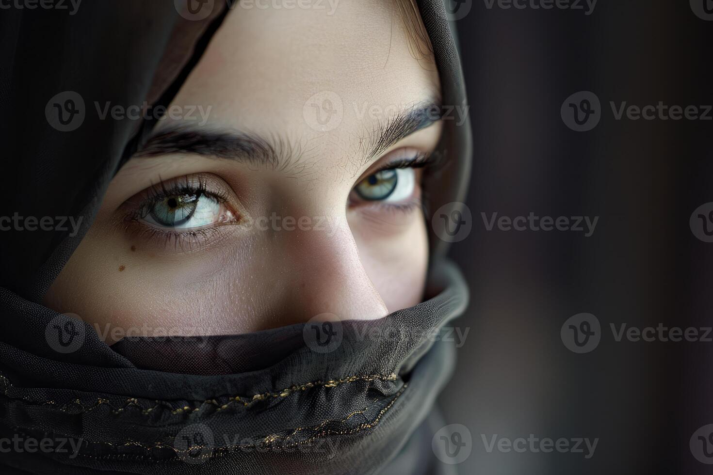 Muslim woman wearing hijab showing expressive eyes photo
