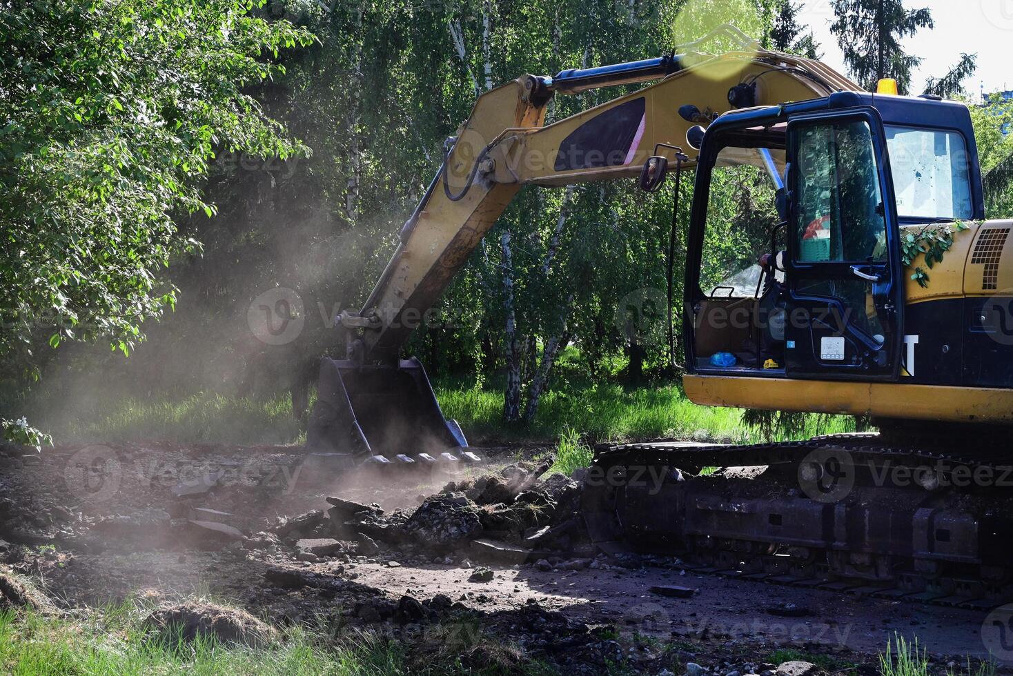 Excavator during earthmoving at open pit on blue sky background On a wonderful day. Construction machinery and earth-moving heavy equipment for excavation, loading, lifting and hauling of c photo