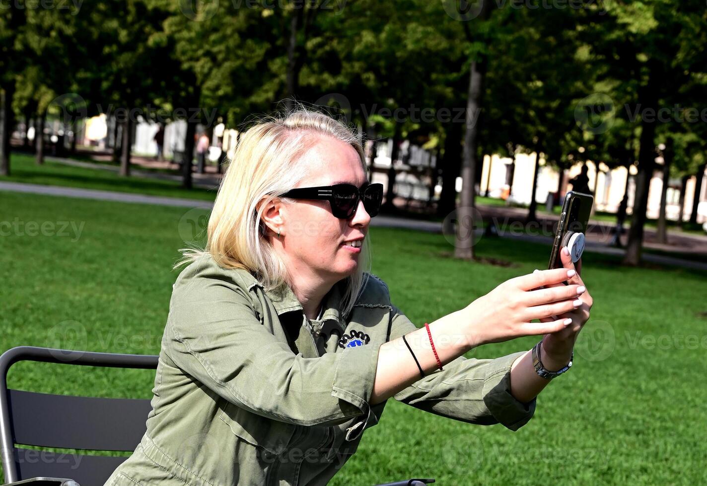 A fashionable girl takes a selfie on a smartphone photo