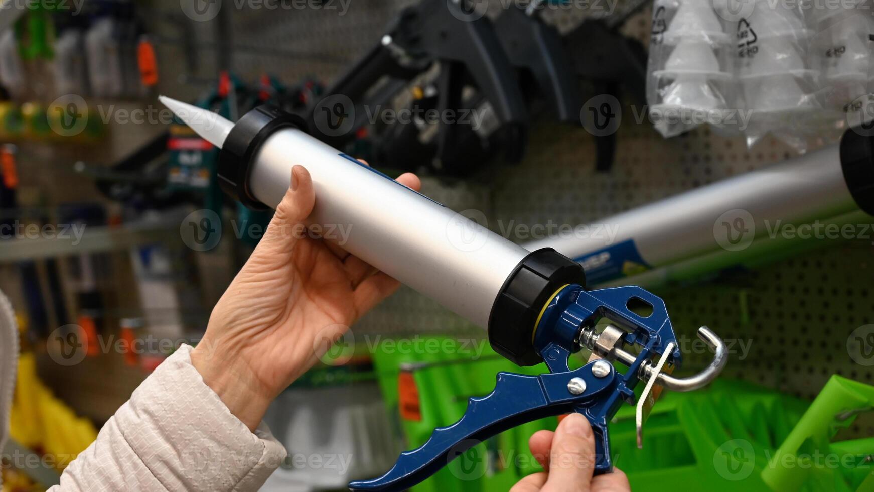 The sealant gun is closed in close-up on a beautiful sunny morning photo