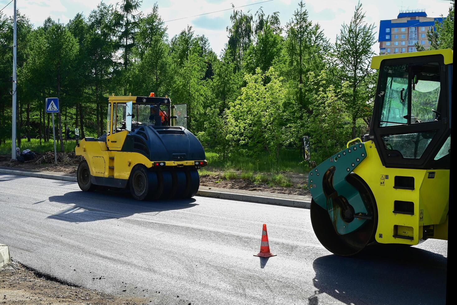 Large view on the road rollers working on the new road construction site on a beautiful sunny morning photo