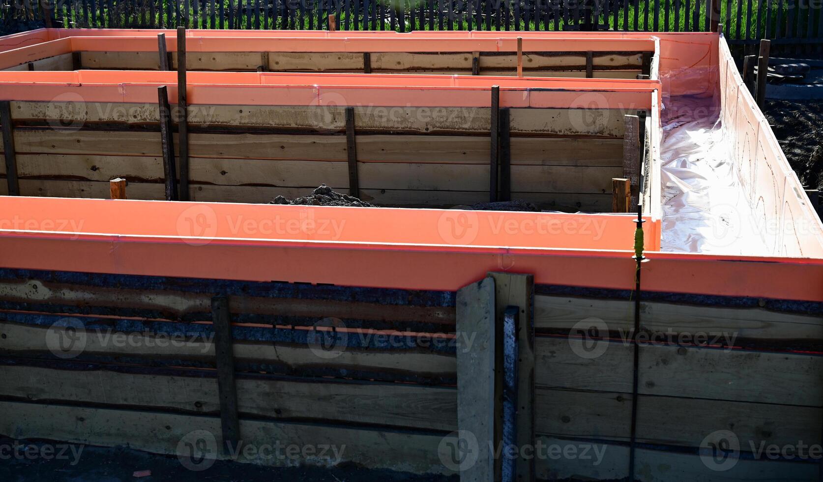 Wooden formwork with metal reinforcement prepared for pouring concrete. on a beautiful sunny morning photo