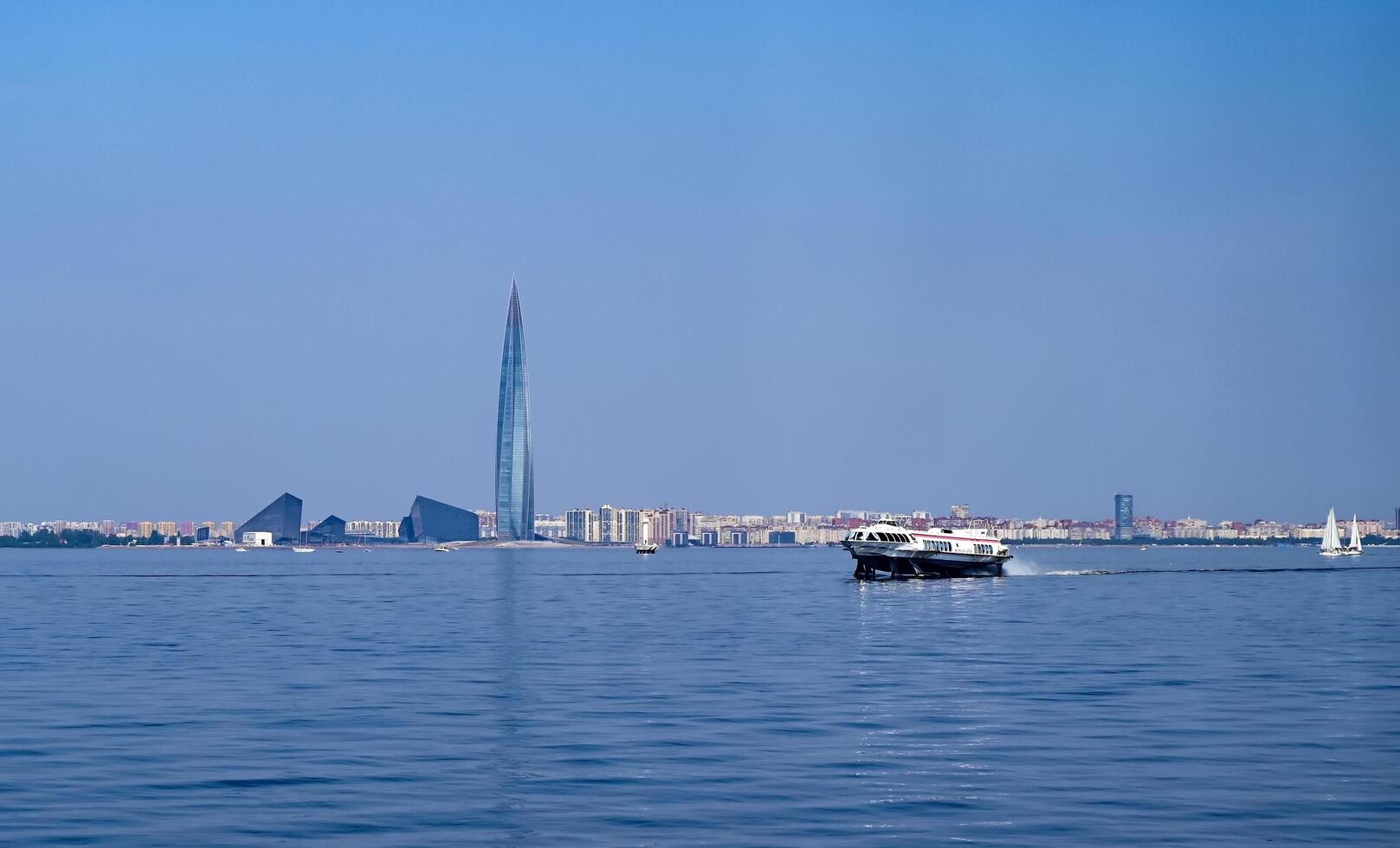 Sea vessel on the river near the city, tourism on a beautiful sunny morning photo