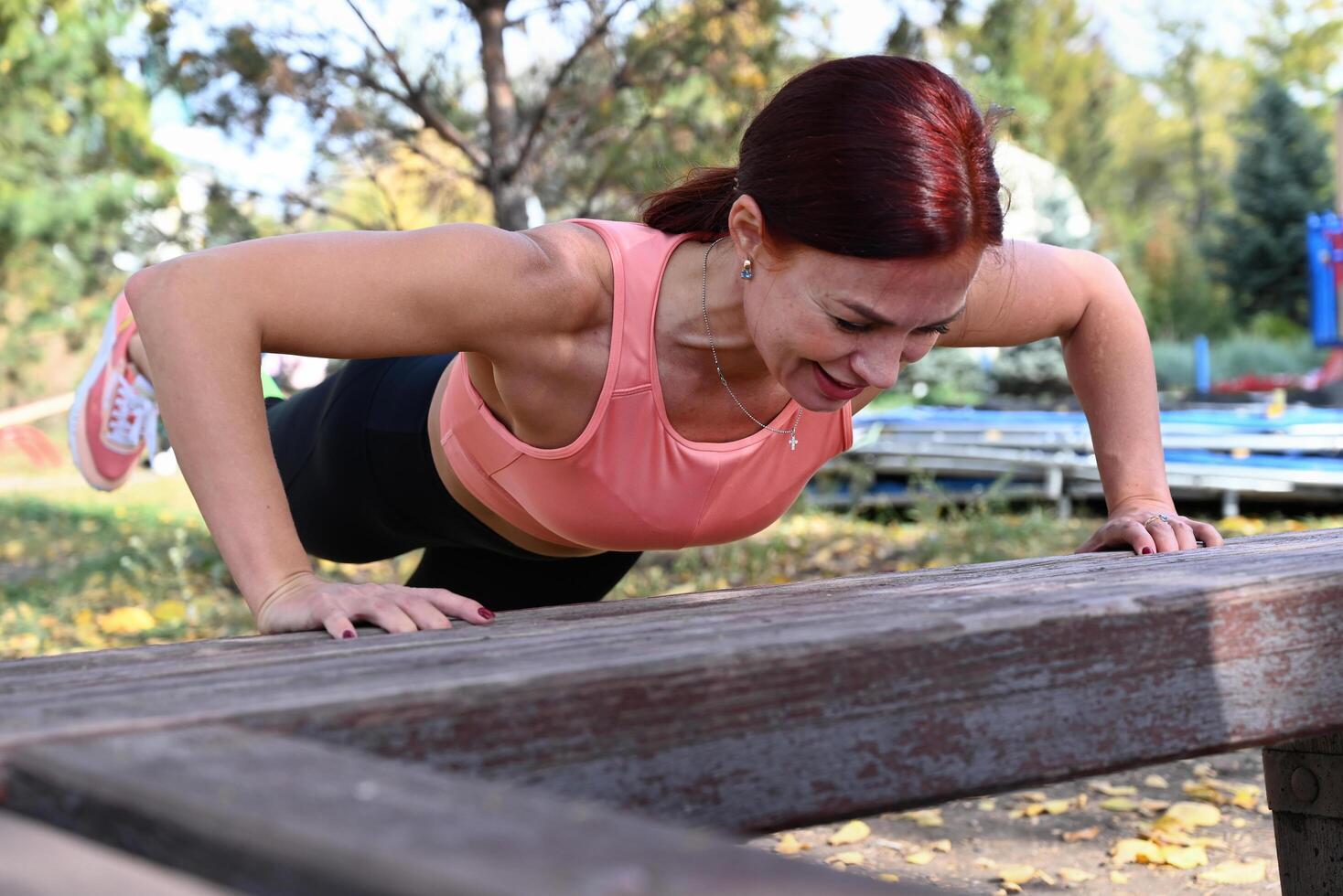 The image captures a woman's workout routine, with her stretching her arms, suggesting a focus on physical fitness and well-being photo