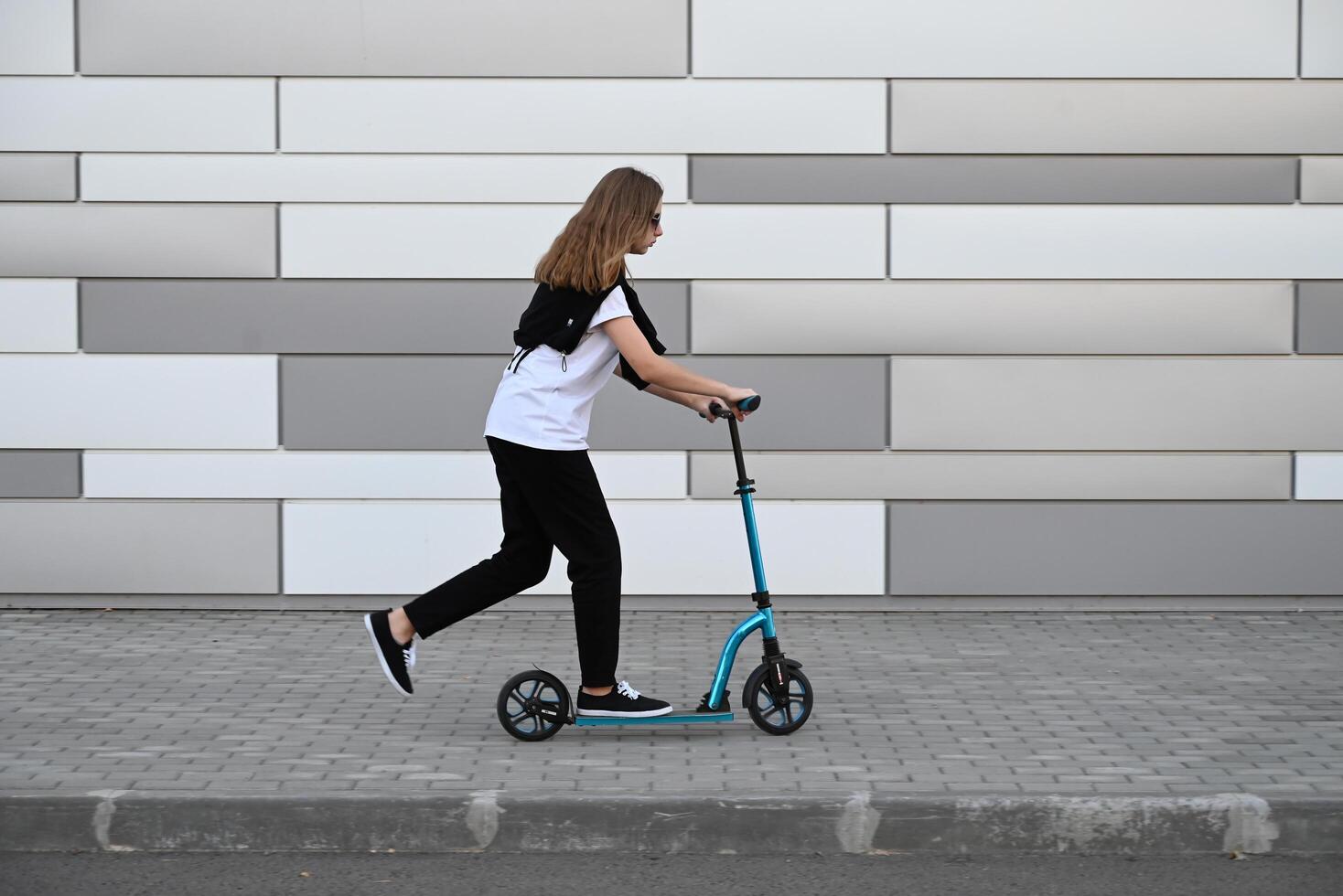The image captures the motion of a person riding a scooter, highlighting a sense of activity and movement photo