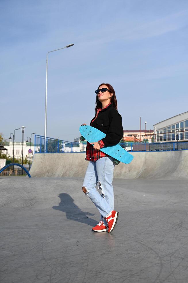 he image portrays a person holding a skateboard, suggesting an active, youthful lifestyle, against an urban backdrop photo
