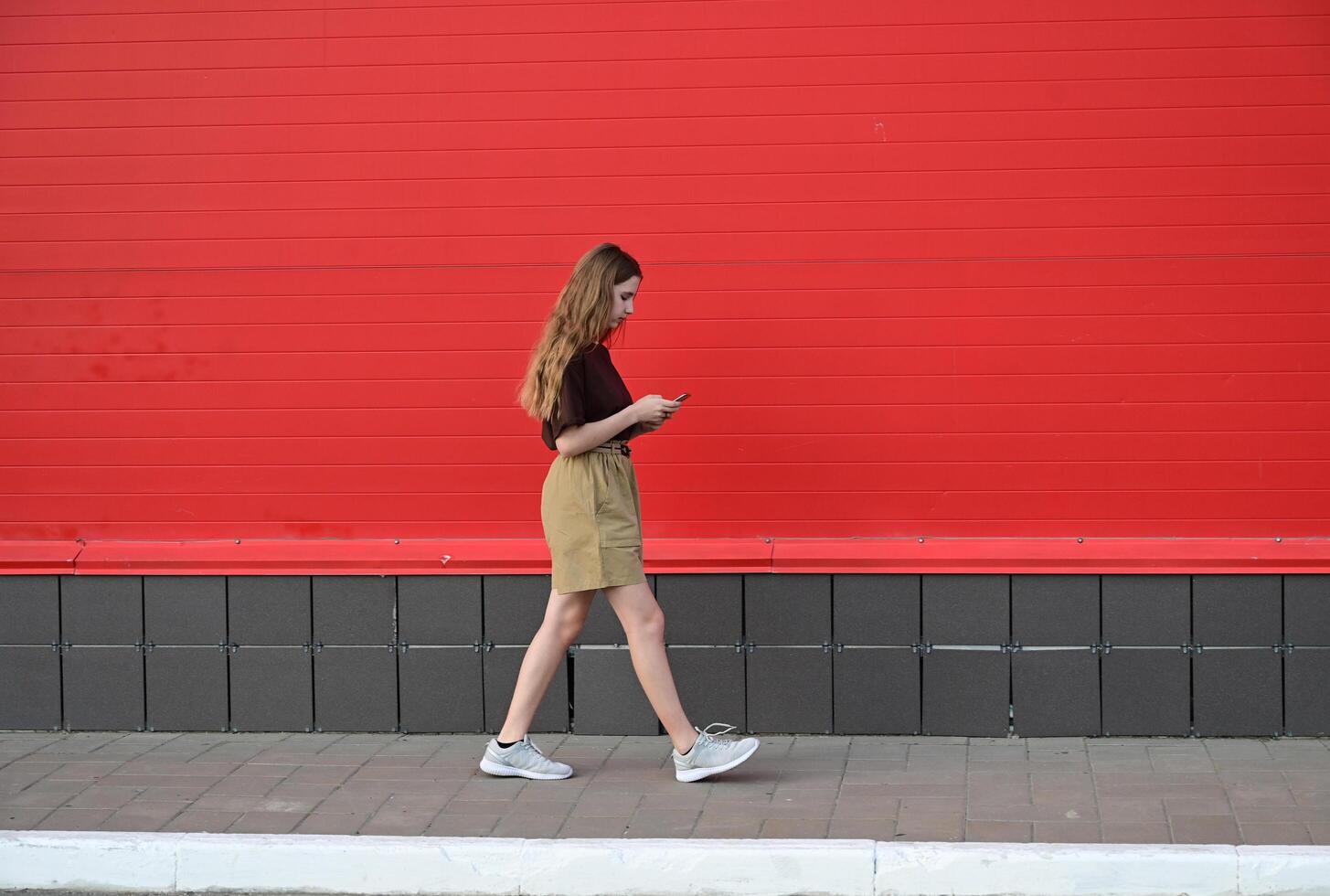 Portrait of a young student reading a message on a mobile phone photo
