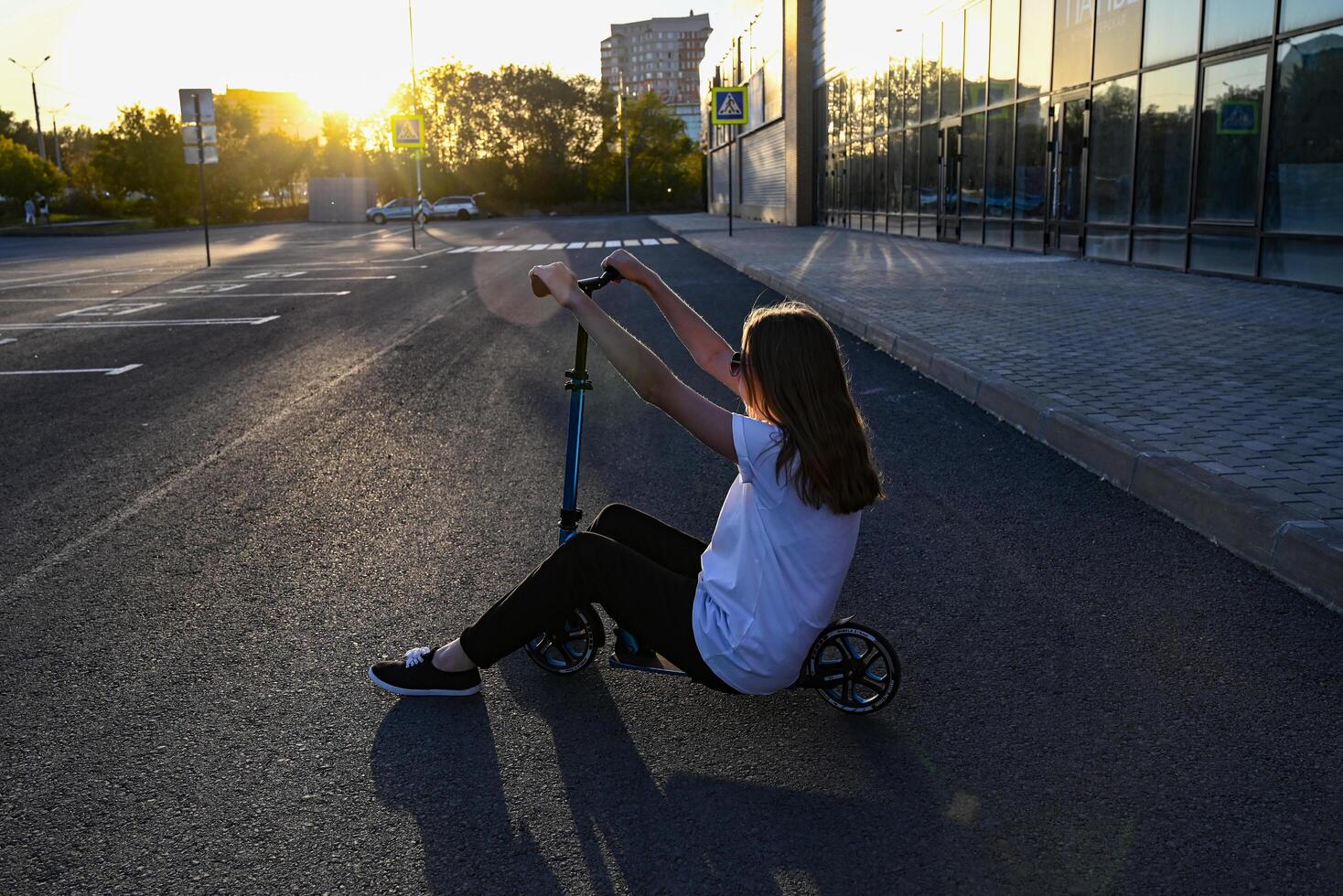 Beautiful and blonde girl practicing long board on the road On a wonderful day with a positive attitude photo