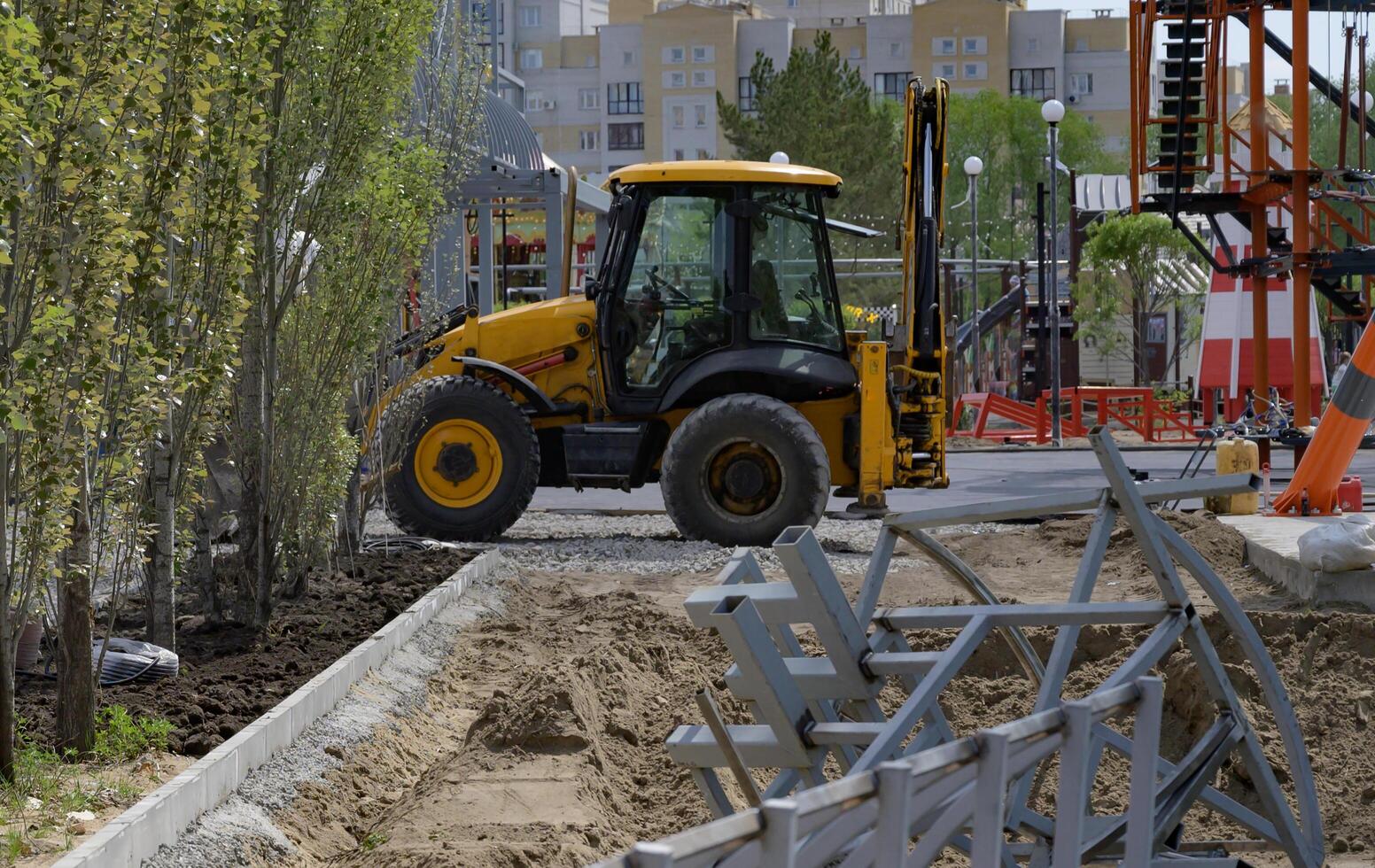 On a wonderful day with a positive attitude excavator is working and digging at construction site photo