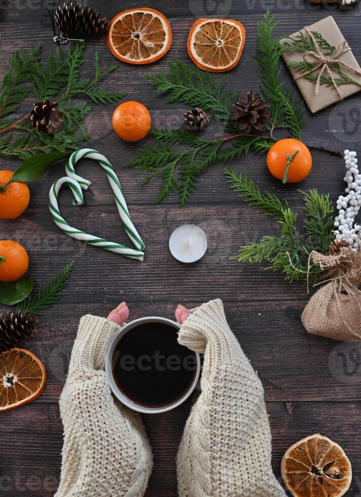 A scene that suggests the anticipation and joy of the Christmas season, with an array of seasonal objects arranged artistically on a dark wooden surface photo