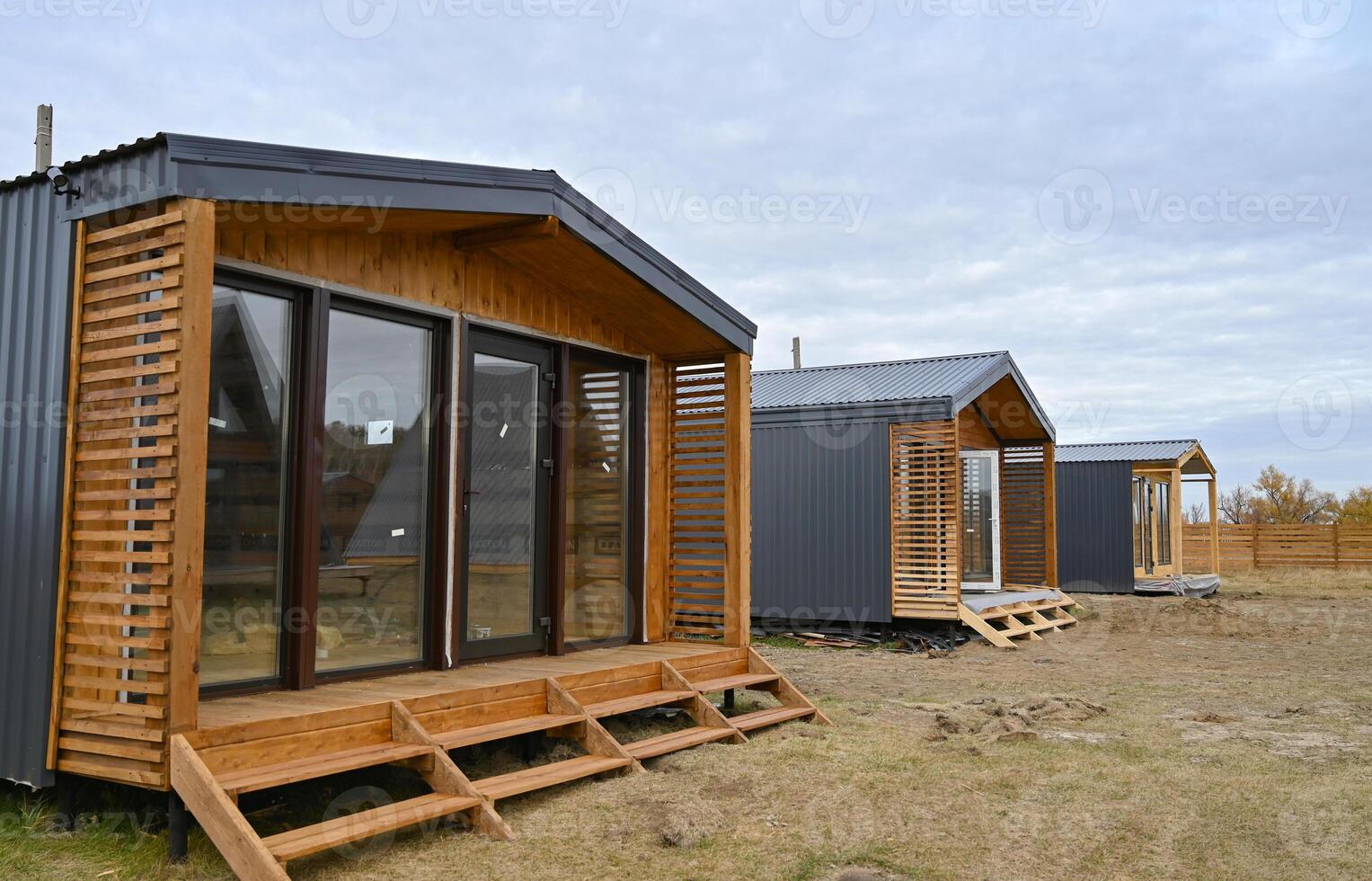 Wooden houses in a triangular summer camp on a wonderful day. summer vacation in an eco-friendly house, summer photo