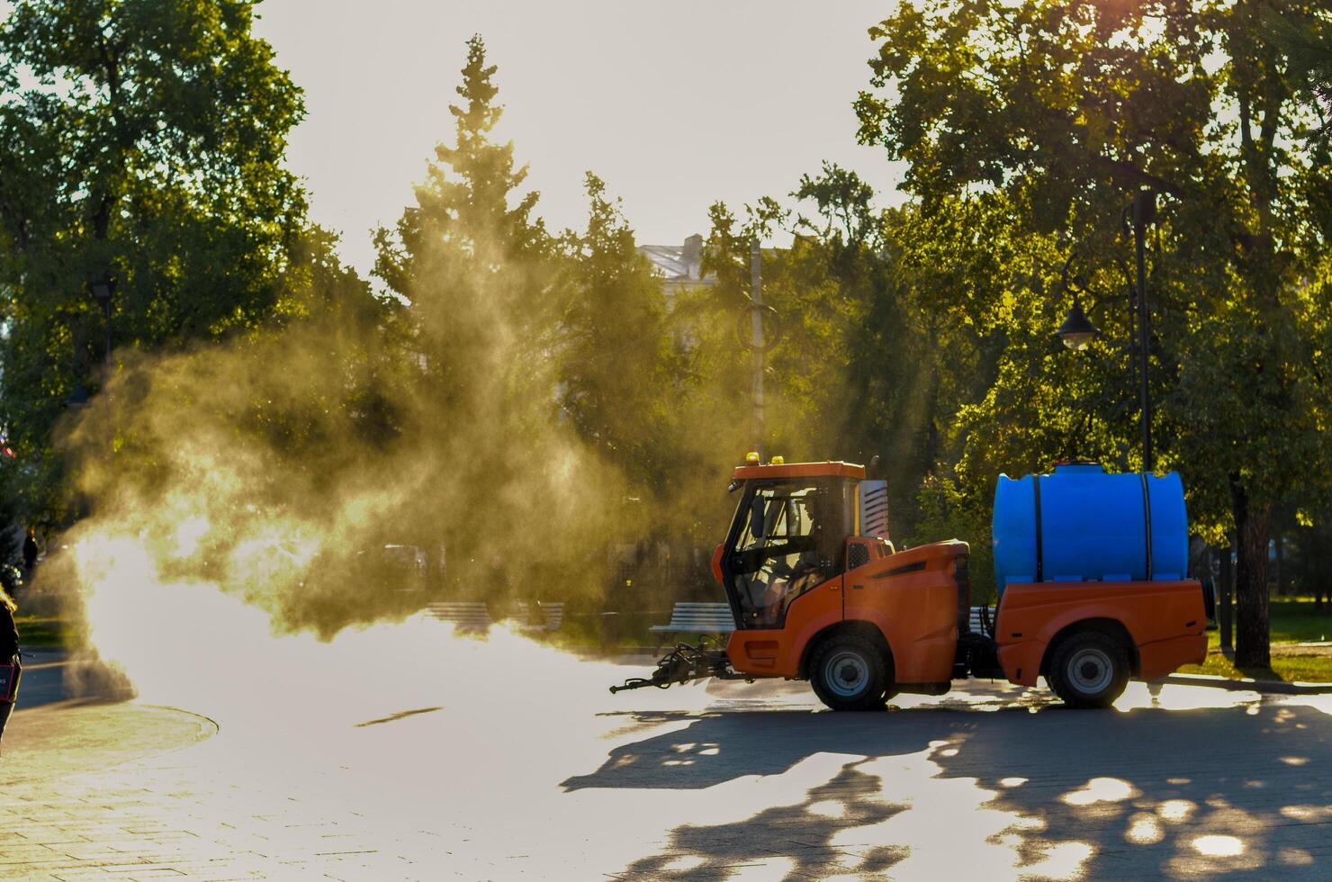 Truck watering a tree by spray water in the park at the morning. photo
