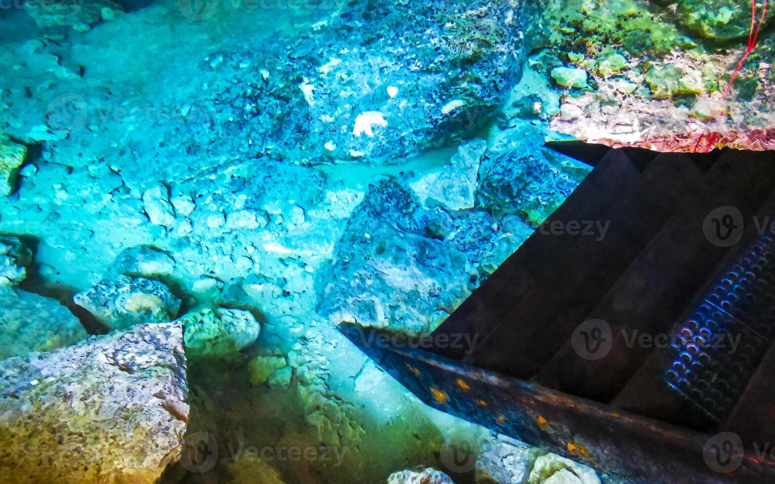 Cenote Park Yaxmuul with stairs steps into the cave with water. photo