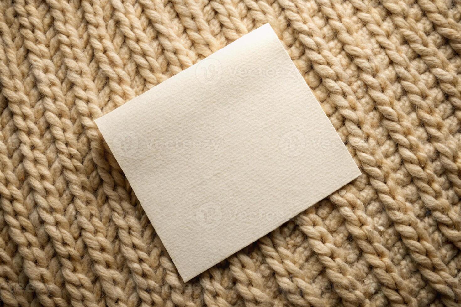 Close-up of a beige knitted fabric with a blank tag for product labeling for business photo