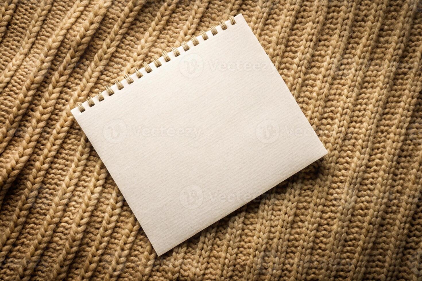 Notebook blank page on knitted texture background for business presentations or templates photo