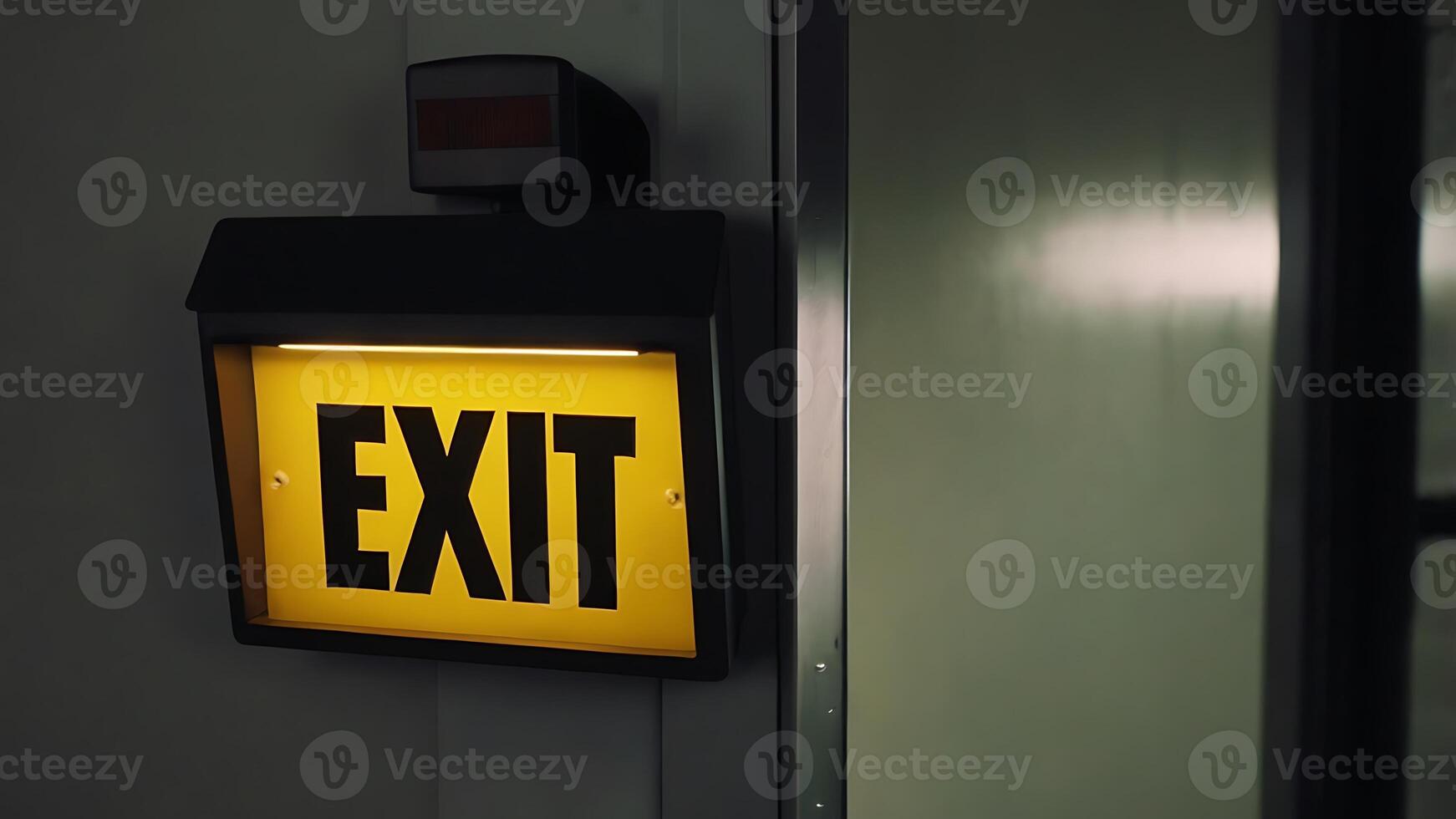 Illuminated Exit Sign with a Yellow Background for Business Applications and Safety photo