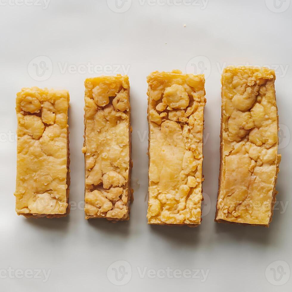 Four rectangular pieces of tempeh arranged in a row for business purposes photo