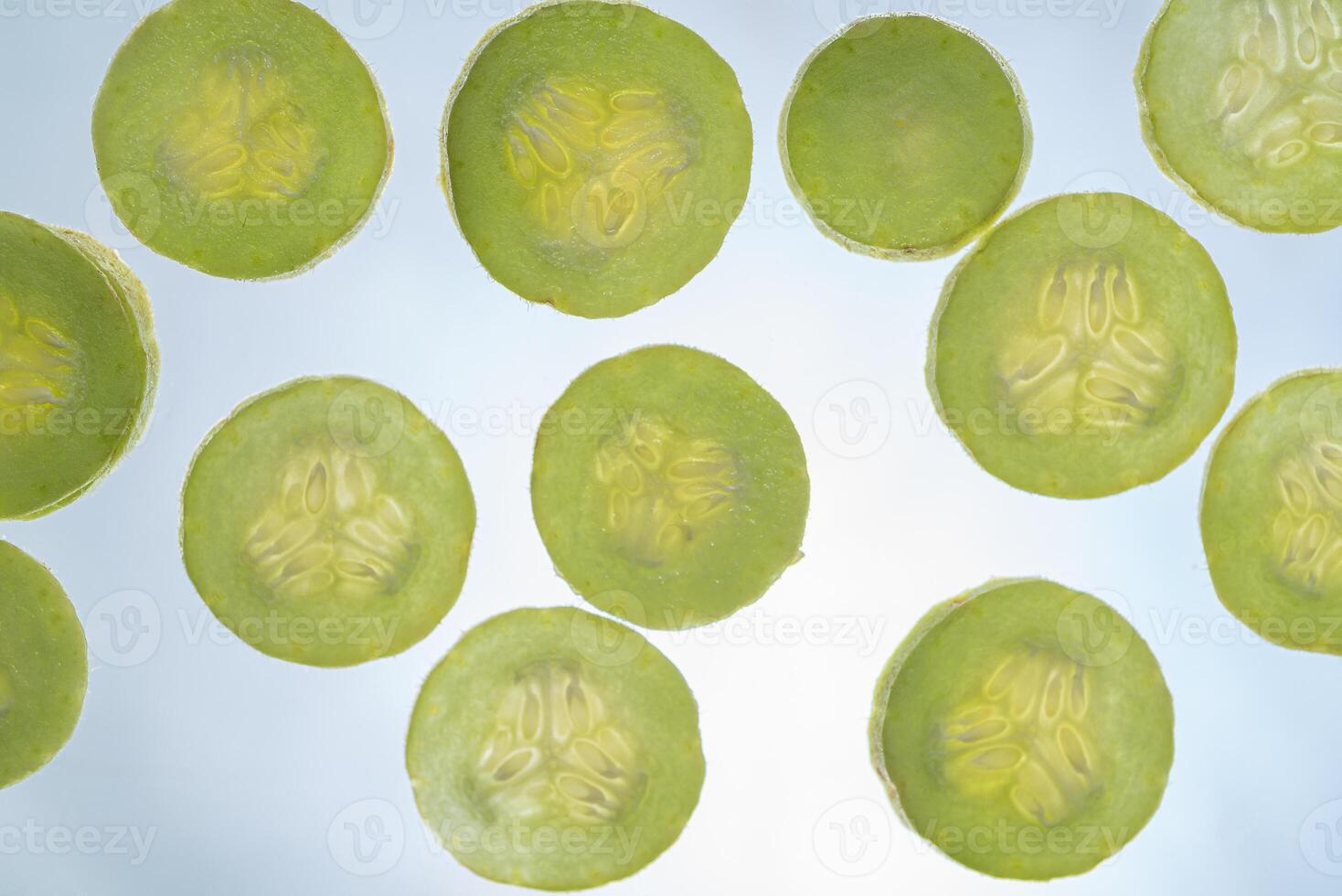 Armenian cucumber slices texture isolated on white background photo