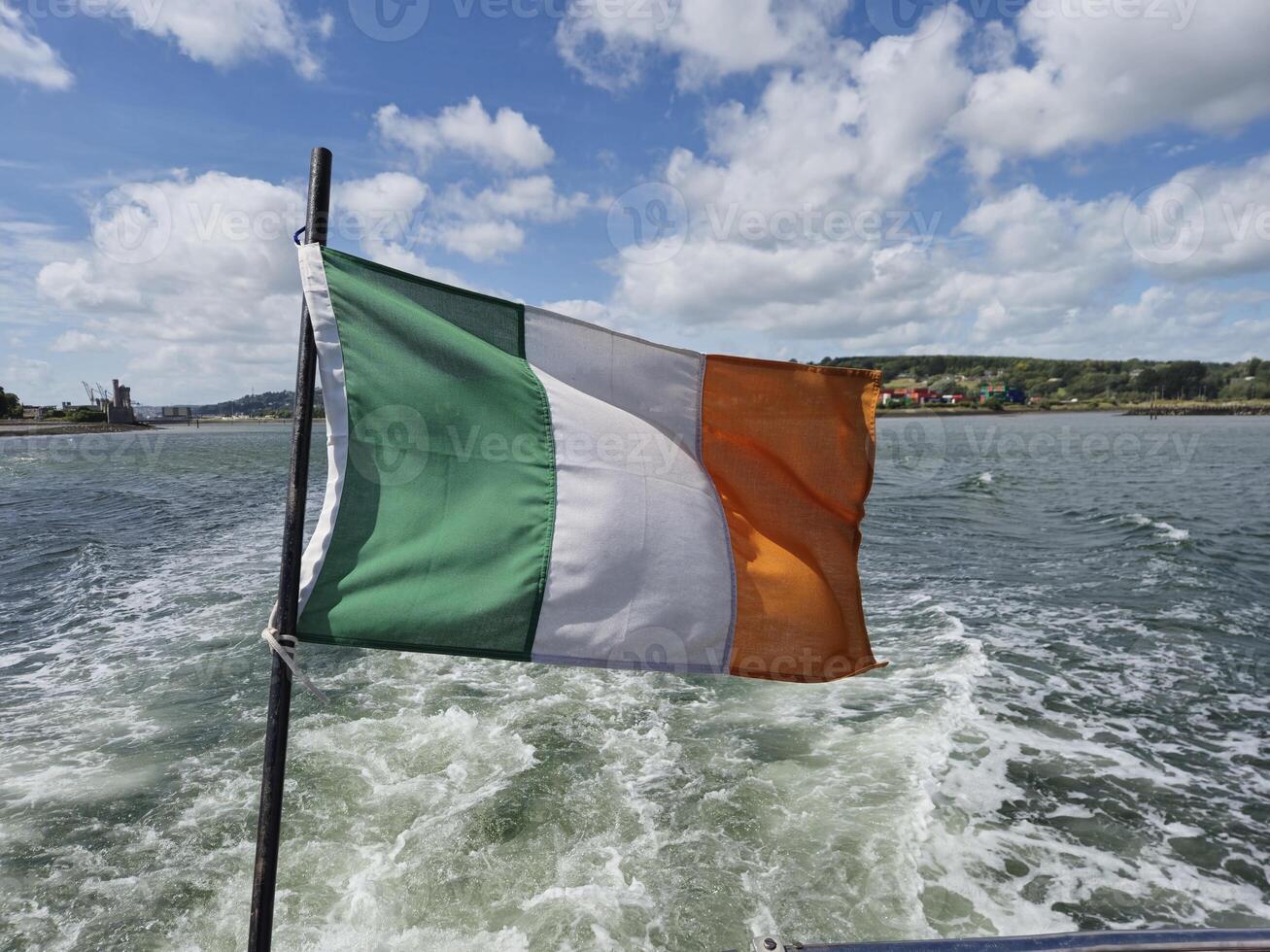 Irish flag waving over river, creative background photo
