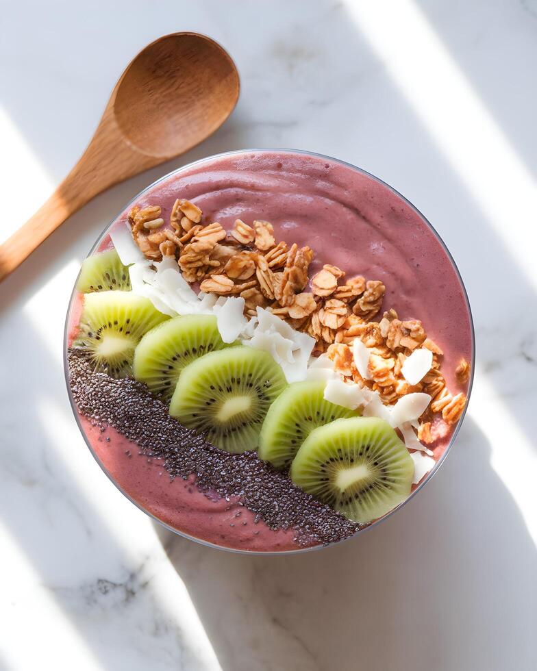 Chocolate smoothie bowl with granola, kiwi and coconut photo