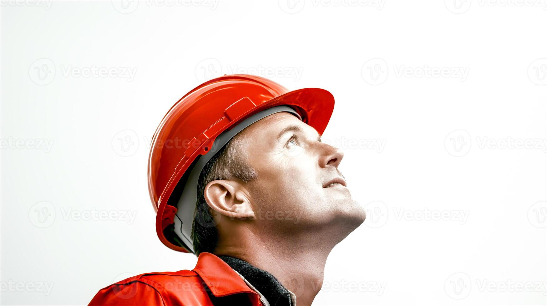 Portrait of a senior engineer wearing an orange hard hat and safety and looking up isolated on a white background. . photo