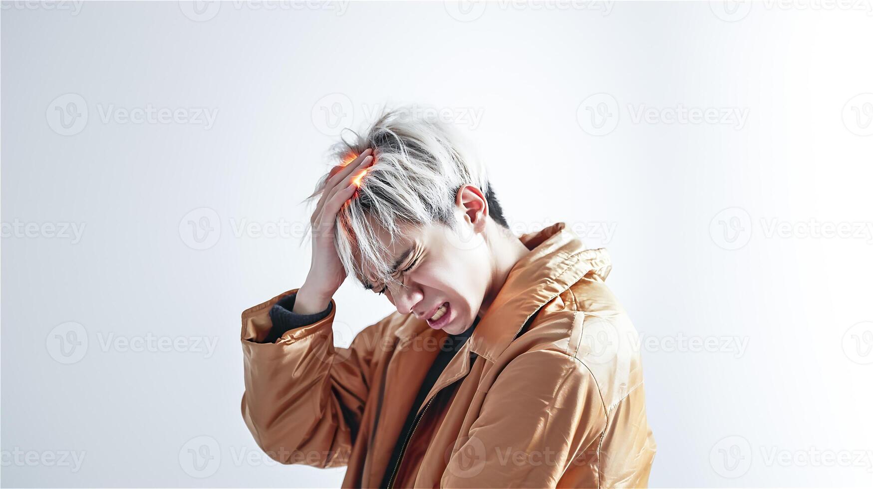 A young man suffering from severe headaches is isolated on a white background. . photo