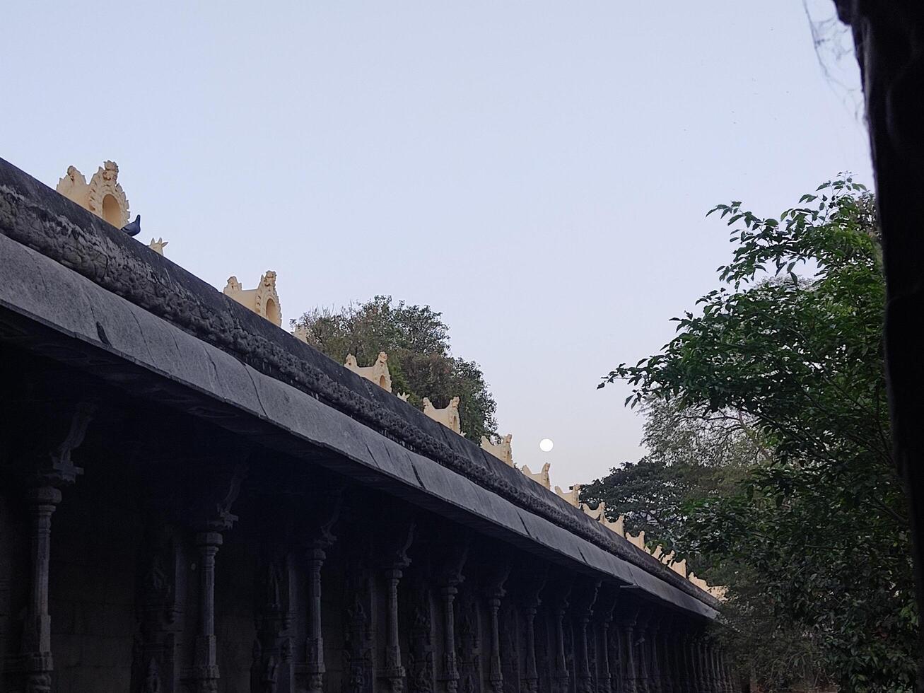 The roof of a temple is covered with statues photo