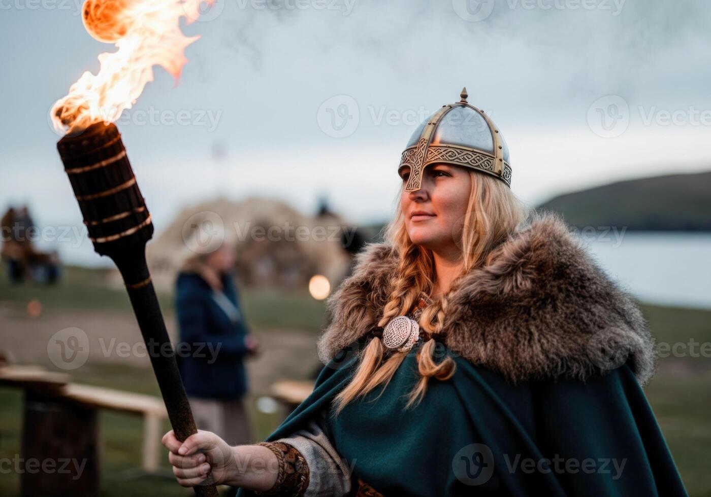 Historical reenactment Viking woman in armor holding torch outdoors. Imbolc festival celebration photo
