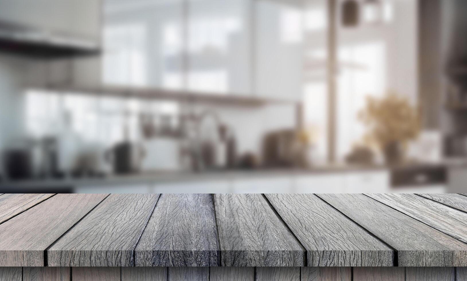 Wooden table top with blurred kitchen in the background photo