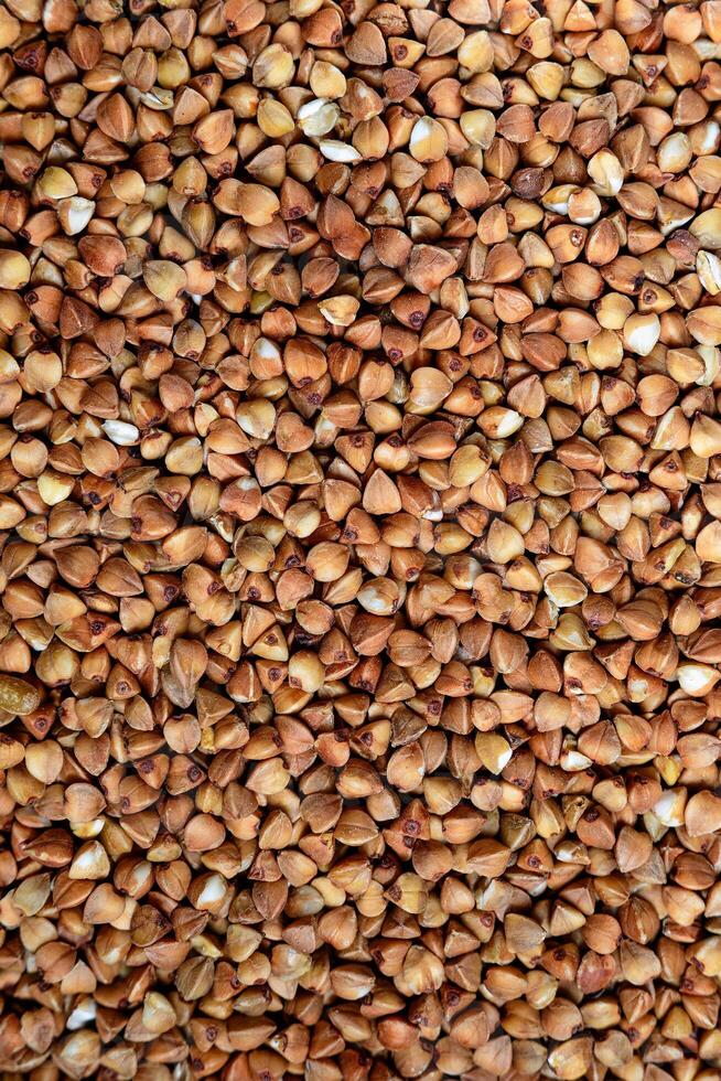 Close-Up View of Buckwheat Groats, vertical- Ideal for Nutrition Articles, Culinary Blogs, and Health-Related Marketing Materials photo