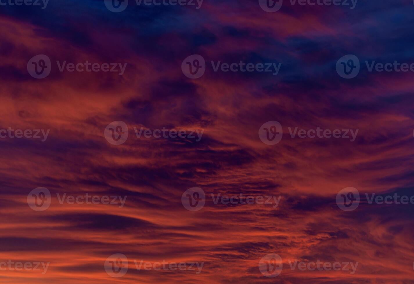Dramatic sunset with fiery orange and red hues swirling through textured clouds. Abstract and intense, evoking a sense of power and awe photo