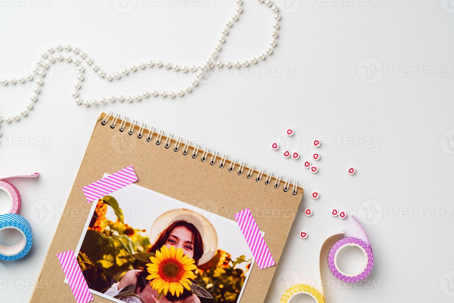Crafting memories with a sunflower photo and decorative elements in a creative workspace
