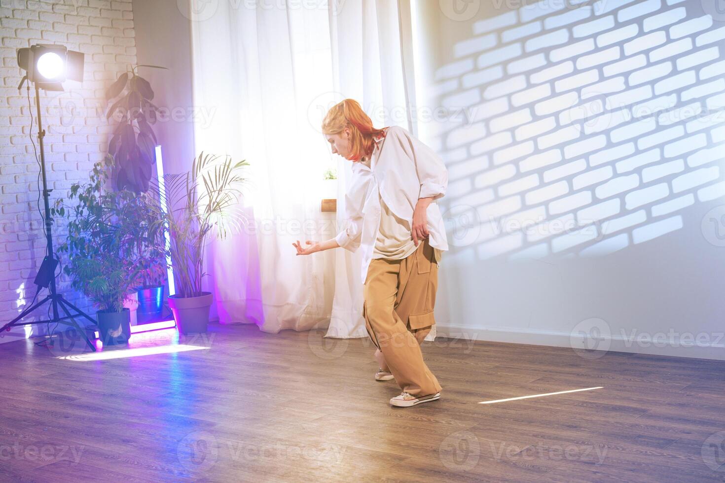 Dynamic dance performance highlighting expressive movement in a well-lit studio during an afternoon session photo